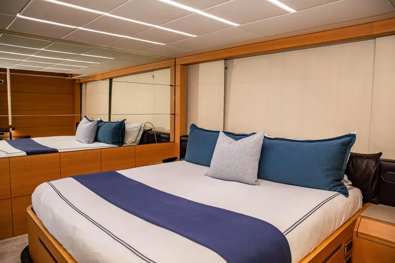 Dorothy Ann Yacht Photos Pics Luxurious bedroom interior on 2012 Pershing 82 yacht with modern design and blue accents.