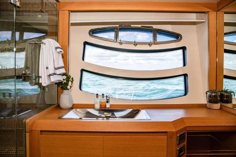 Dorothy Ann Yacht Photos Pics Luxurious bathroom interior on 2012 Pershing 82 yacht with ocean view through unique windows.