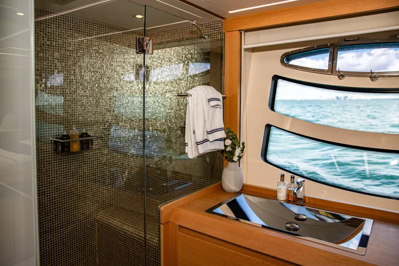 Dorothy Ann Yacht Photos Pics Luxurious bathroom on 2012 Pershing 82 yacht with ocean view and modern amenities.