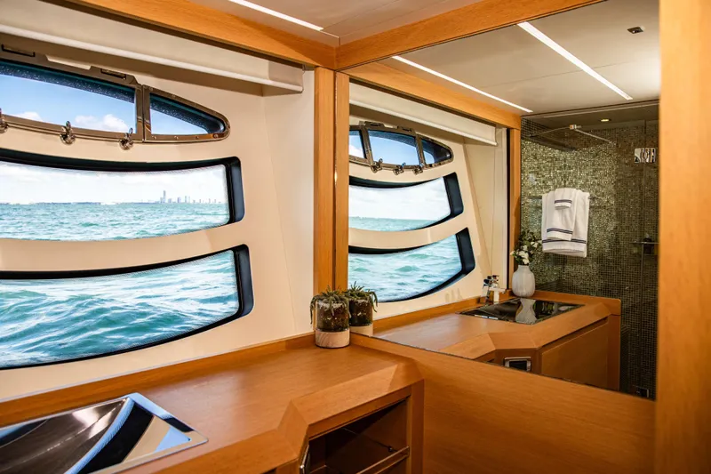 Dorothy Ann Yacht Photos Pics Luxurious bathroom interior of 2012 Pershing 82 yacht with ocean view windows.