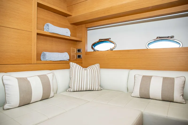 Dorothy Ann Yacht Photos Pics Luxurious interior of 2012 Pershing 82 yacht with elegant cushions and wooden shelving.