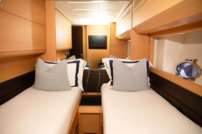 Dorothy Ann Yacht Photos Pics Luxurious twin cabin interior of 2012 Pershing 82 yacht with modern wood finish.