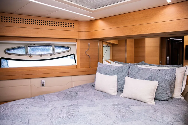 Dorothy Ann Yacht Photos Pics Luxurious bedroom interior of 2012 Pershing 82 yacht with modern design and cozy bedding.