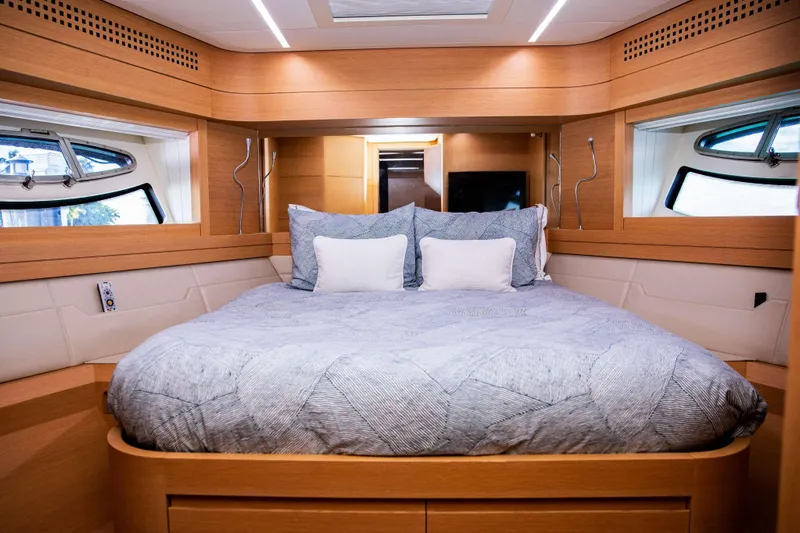 Dorothy Ann Yacht Photos Pics Luxurious bedroom interior of 2012 Pershing 82 yacht with modern design and cozy bedding.