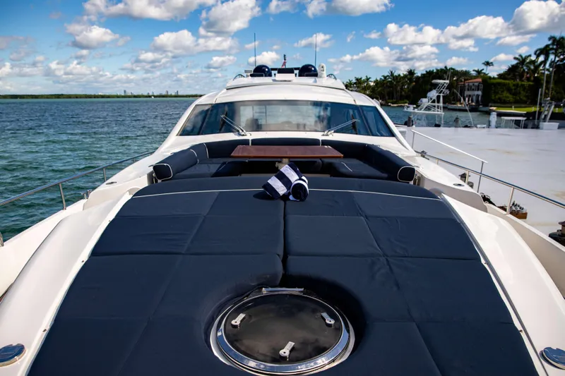 Dorothy Ann Yacht Photos Pics Luxury 2012 Pershing 82 yacht deck with sunbathing area, ocean view, and clear skies.