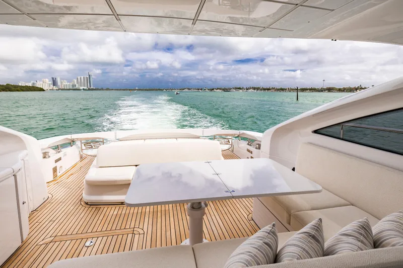 Sea Suite I Yacht Photos Pics Luxurious 2021 Pershing 62 yacht deck with ocean view and elegant seating area.