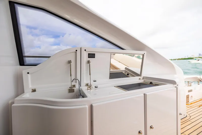 Sea Suite I Yacht Photos Pics Luxury yacht Pershing 62 (2021) with sleek outdoor kitchenette and ocean view.