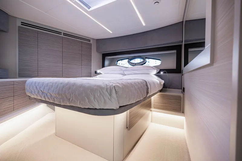Sea Suite I Yacht Photos Pics Luxurious bedroom interior of 2021 Pershing 62 yacht with modern design and ambient lighting.