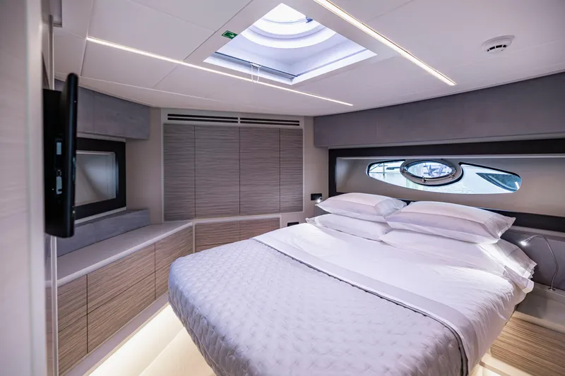 Sea Suite I Yacht Photos Pics Luxurious bedroom interior of 2021 Pershing 62 yacht with modern design and skylight.