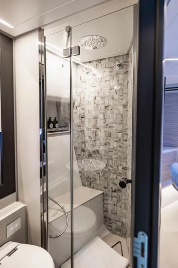 Sea Suite I Yacht Photos Pics Luxurious bathroom interior on a 2021 Pershing 62 yacht, featuring modern design and elegant fixtures.