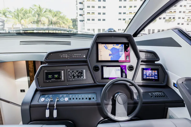 Sea Suite I Yacht Photos Pics Cockpit of 2021 Pershing 62 yacht with advanced navigation displays and controls.