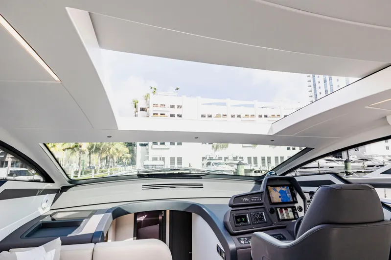 Sea Suite I Yacht Photos Pics Interior view of 2021 Pershing 62 yacht cockpit with modern navigation system and panoramic windows.