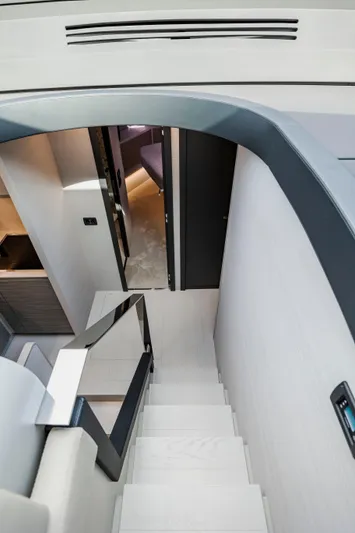 Sea Suite I Yacht Photos Pics Interior staircase of 2021 Pershing 62 yacht, featuring modern design and sleek finishes.