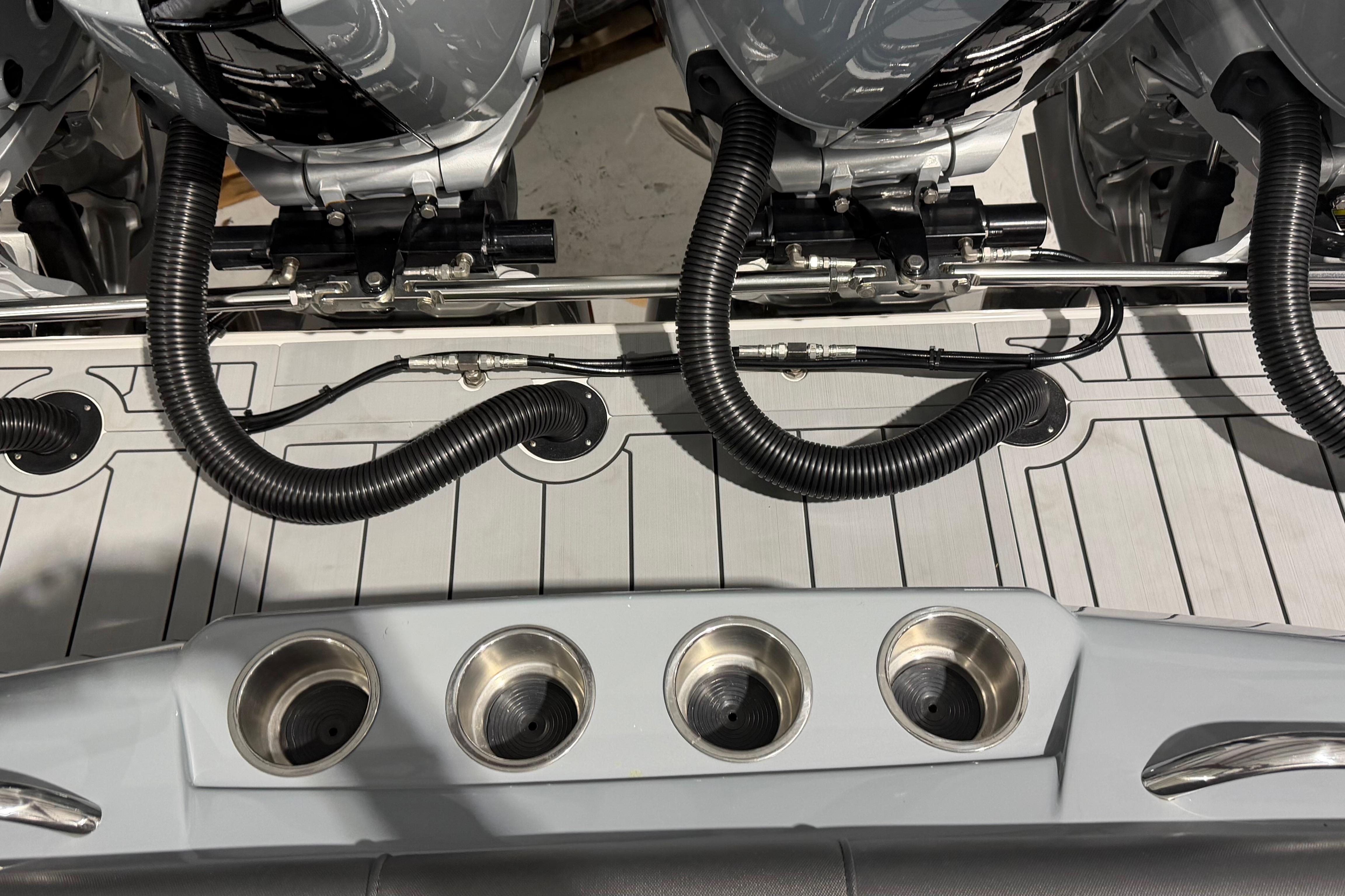 2025 Nor-Tech 390 Sport Center Console boat with dual outboard engines and cup holders.