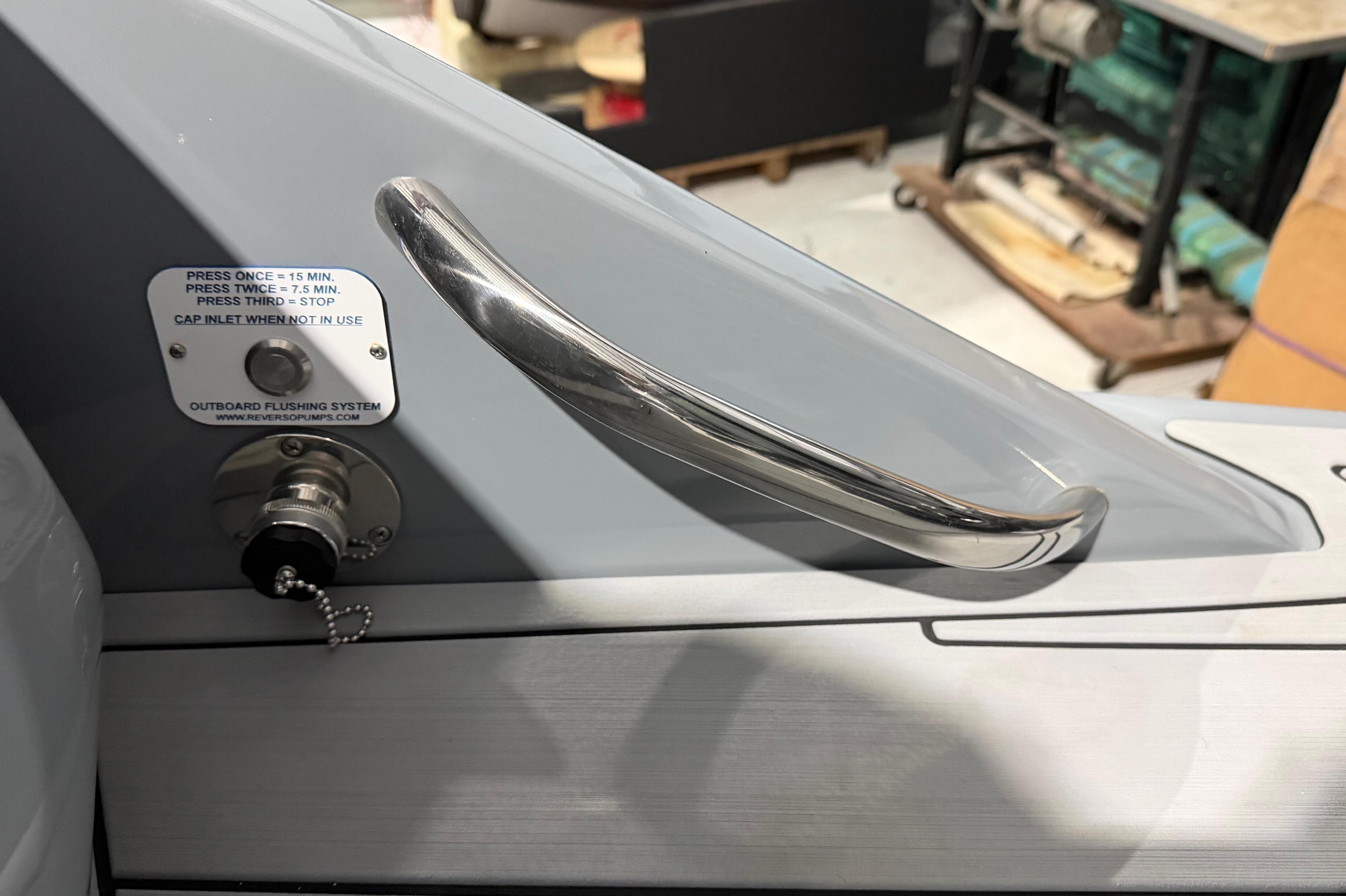 2025 Nor-Tech 390 Sport Center Console outboard flushing system with metal handle detail.