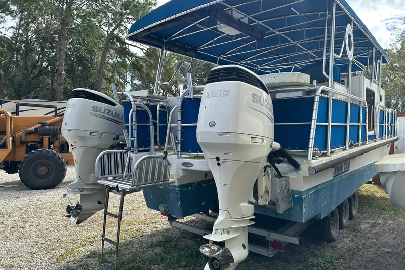  Yacht Photos Pics 1999 Catamaran Coaches 31 with dual Suzuki outboard motors, parked outdoors.