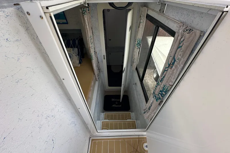  Yacht Photos Pics Interior view of a 1999 Catamaran Coaches 31, featuring a narrow hallway and window.