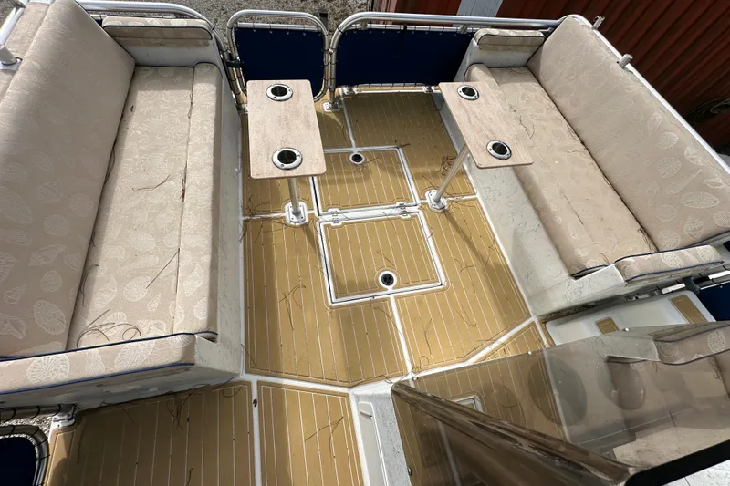  Yacht Photos Pics 1999 Catamaran Coaches 31 interior with beige seating and wooden deck.