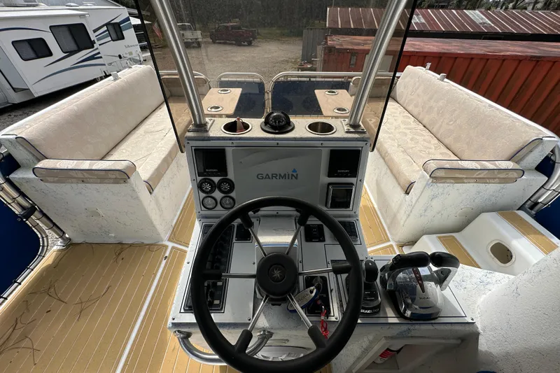  Yacht Photos Pics 1999 Catamaran Coaches 31 boat interior with steering wheel and Garmin navigation system.