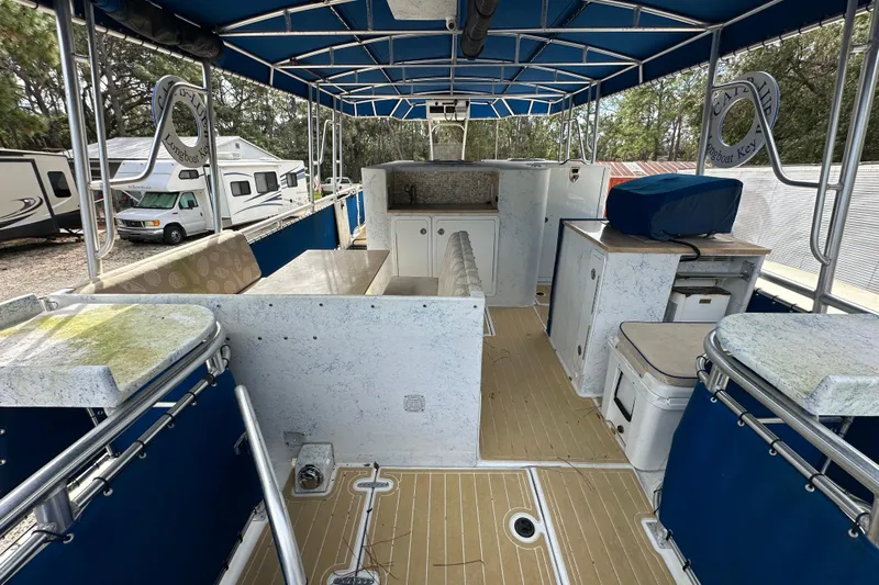  Yacht Photos Pics 1999 Catamaran Coaches 31 interior with blue canopy, seating, and storage compartments.