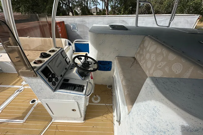  Yacht Photos Pics 1999 Catamaran Coaches 31 interior with steering console and cushioned seating.