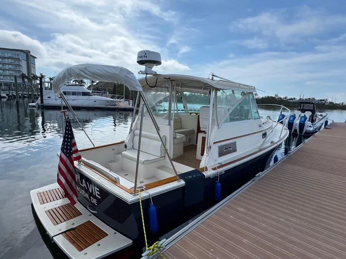 C'est La Vie Yacht Photos Pics 2010 Bruckmann Bluestar 29.9 docked, featuring a sleek design and American flag.