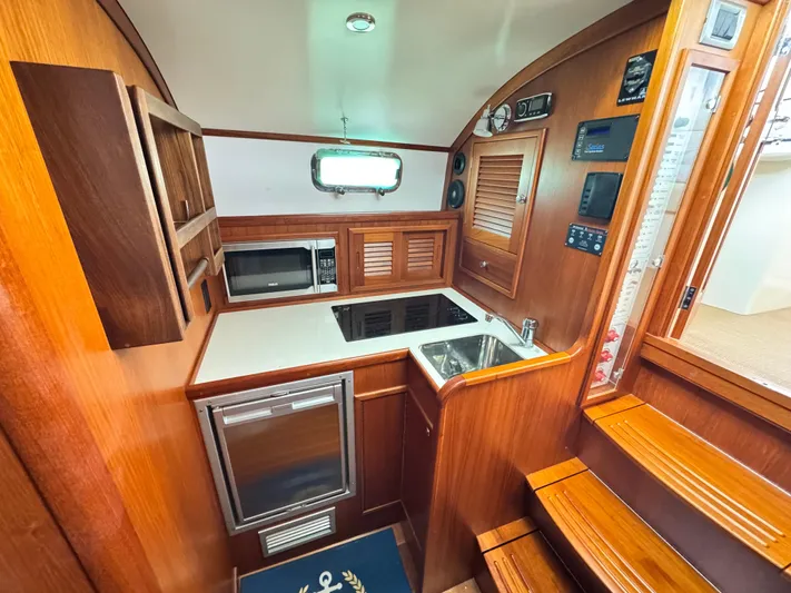 C'est La Vie Yacht Photos Pics Interior of 2010 Bruckmann Bluestar 29.9 yacht kitchen with wood finish and modern appliances.