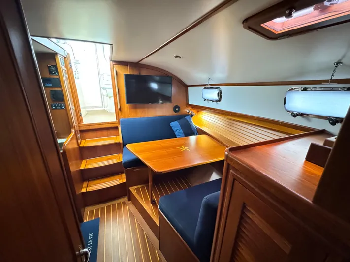 C'est La Vie Yacht Photos Pics Interior of 2010 Bruckmann Bluestar 29.9 yacht with wooden finish and cozy seating area.
