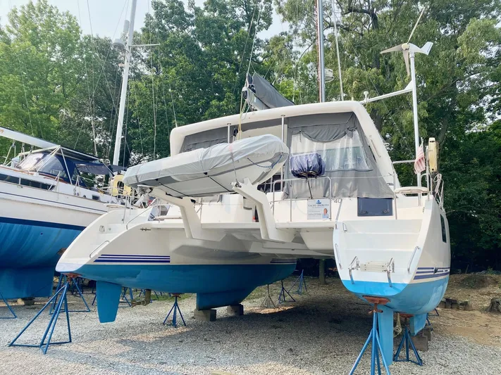 Ronin Yacht Photos Pics 2016 Celtic Yachts 40 catamaran on stands, surrounded by trees and other boats.