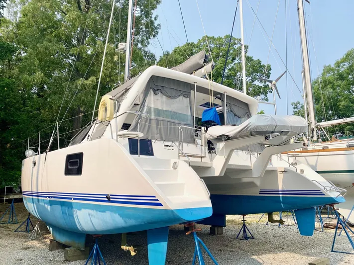 Ronin Yacht Photos Pics 2016 Celtic Yachts 40 catamaran on stands, blue and white hull, outdoor setting.