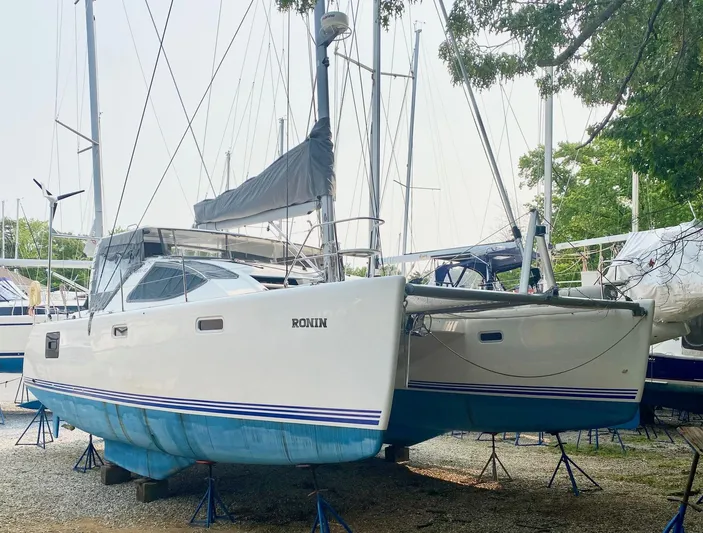 Ronin Yacht Photos Pics 2016 Celtic Yachts 40 catamaran on stands, white hull, blue accents, outdoor setting.