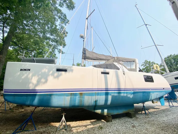 Ronin Yacht Photos Pics 2016 Celtic Yachts 40 sailboat on stands, white hull with blue stripe, outdoors.