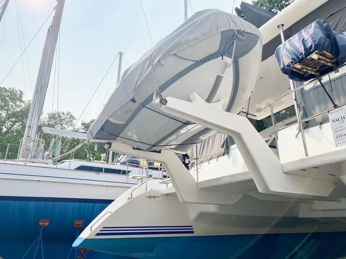 Ronin Yacht Photos Pics Celtic Yachts 40, 2016 model, with a covered dinghy on davits, docked in a marina.