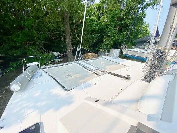 Ronin Yacht Photos Pics 2016 Celtic Yachts 40 catamaran deck with netting, surrounded by lush greenery.