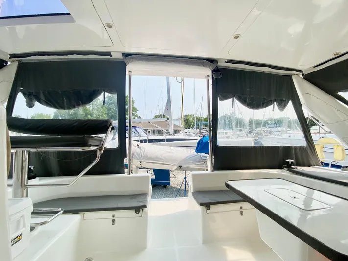 Ronin Yacht Photos Pics Interior view of 2016 Celtic Yachts 40, featuring seating and table, with marina backdrop.