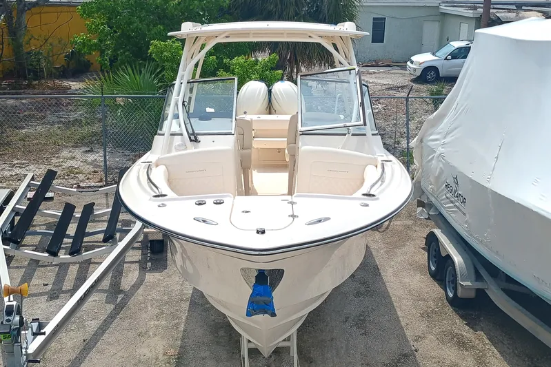  Yacht Photos Pics 2025 Grady-White Freedom 275 boat, docked outdoors, showcasing sleek design and spacious seating.