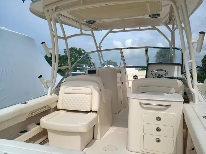  Yacht Photos Pics 2025 Grady-White Freedom 275 boat interior with seating and helm station.