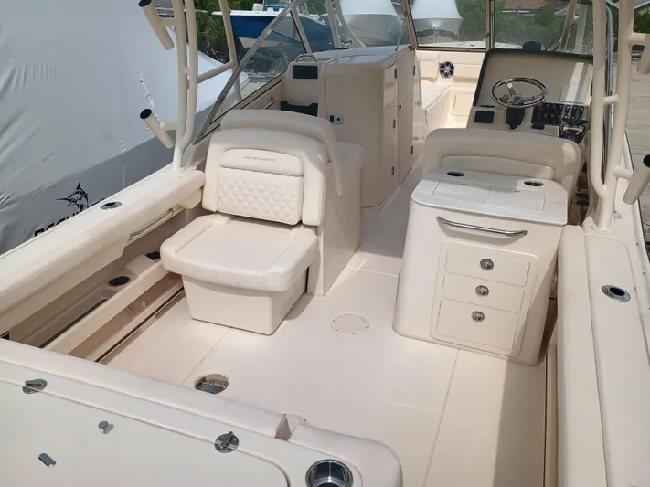  Yacht Photos Pics 2025 Grady-White Freedom 275 boat interior with seating and helm station.