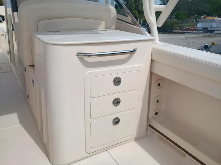  Yacht Photos Pics 2025 Grady-White Freedom 275 boat interior with storage drawers and sleek design.