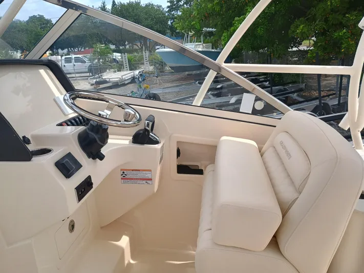  Yacht Photos Pics 2025 Grady-White Freedom 275 boat interior with steering wheel and comfortable seating.