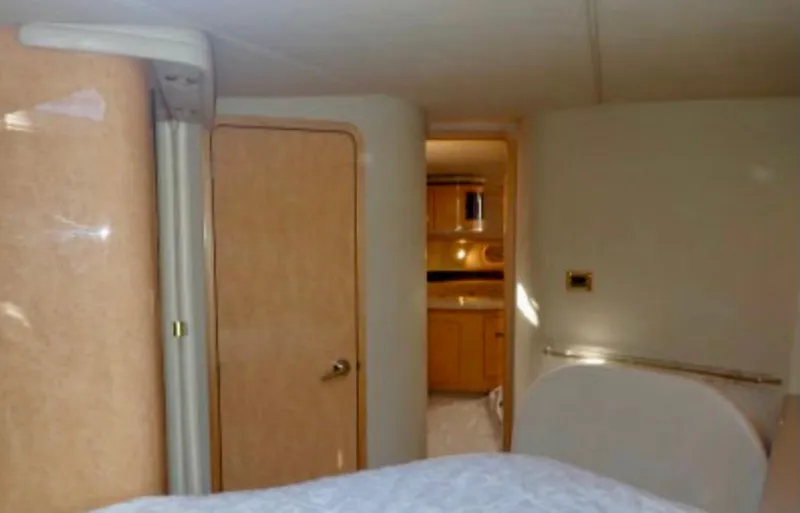  Yacht Photos Pics Interior of 1998 Sea Ray 500 Sundancer yacht, featuring a cozy cabin and wooden door.
