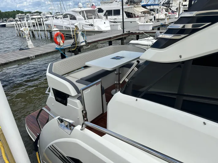 Sea Addendum Yacht Photos Pics 2021 Galeon 425 HTS yacht docked at marina, featuring sleek design and outdoor seating area.