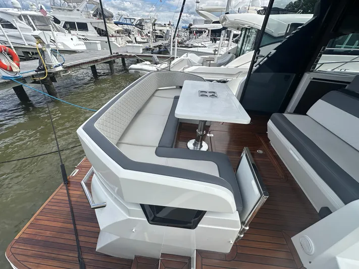 Sea Addendum Yacht Photos Pics 2021 Galeon 425 HTS yacht with elegant outdoor seating and table on teak deck.