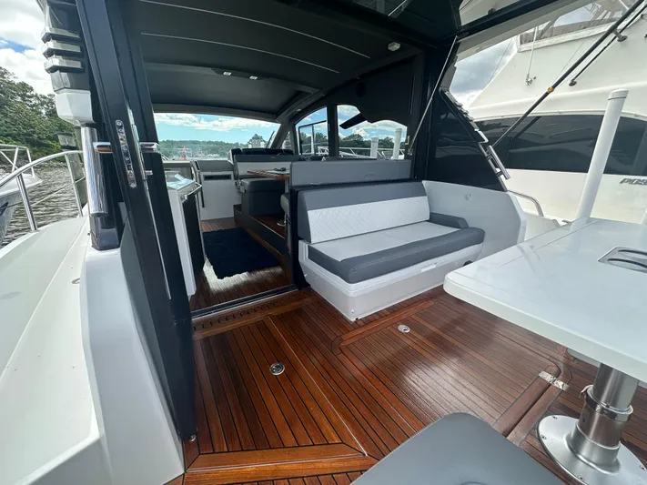 Sea Addendum Yacht Photos Pics 2021 Galeon 425 HTS yacht interior with sleek seating and polished wood flooring.