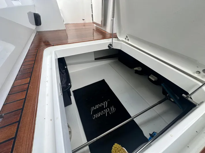 Sea Addendum Yacht Photos Pics Storage compartment on 2021 Galeon 425 HTS yacht with wooden deck and welcome mat.