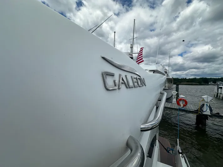 Sea Addendum Yacht Photos Pics Galeon 425 HTS yacht, 2021 model, docked with American flag, under cloudy sky.