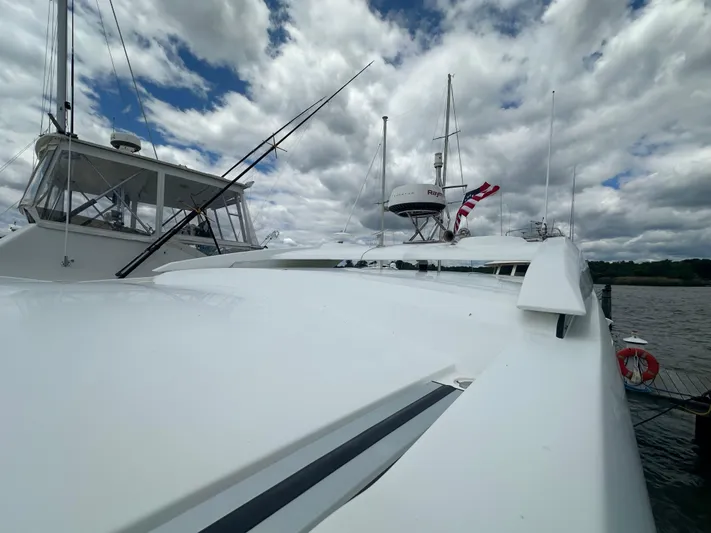 Sea Addendum Yacht Photos Pics Galeon 425 HTS 2021 yacht on water under cloudy sky, featuring sleek design and American flag.