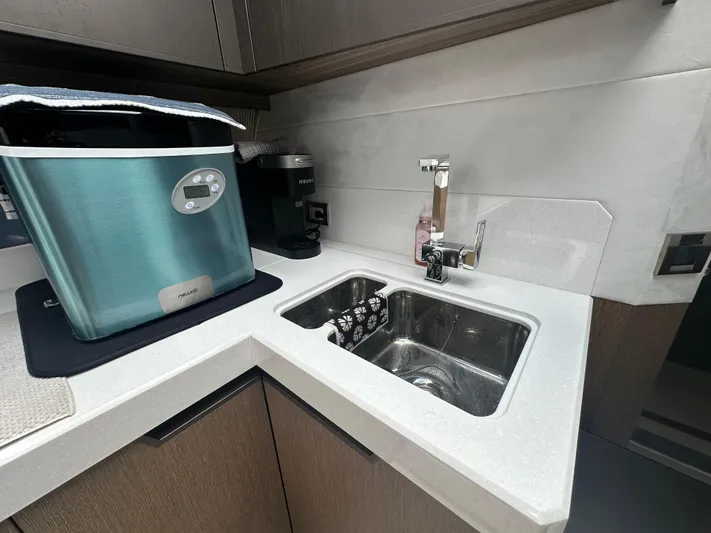Sea Addendum Yacht Photos Pics Modern kitchen sink area on 2021 Galeon 425 HTS yacht with appliances.