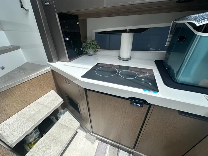 Sea Addendum Yacht Photos Pics Modern kitchen area in a 2021 Galeon 425 HTS yacht with induction cooktop.
