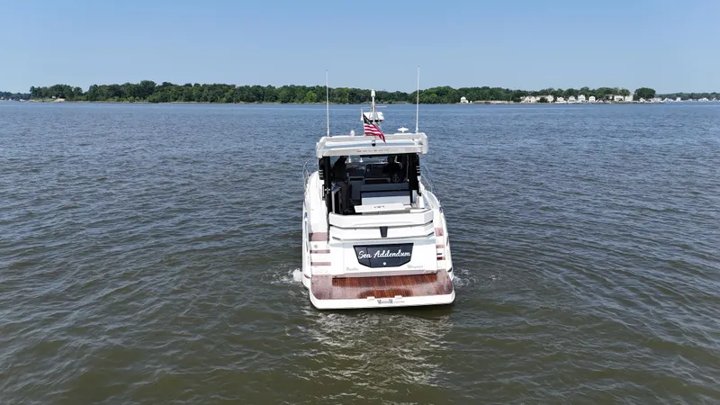 Sea Addendum Yacht Photos Pics 2021 Galeon 425 HTS yacht cruising on a calm lake under a clear blue sky.